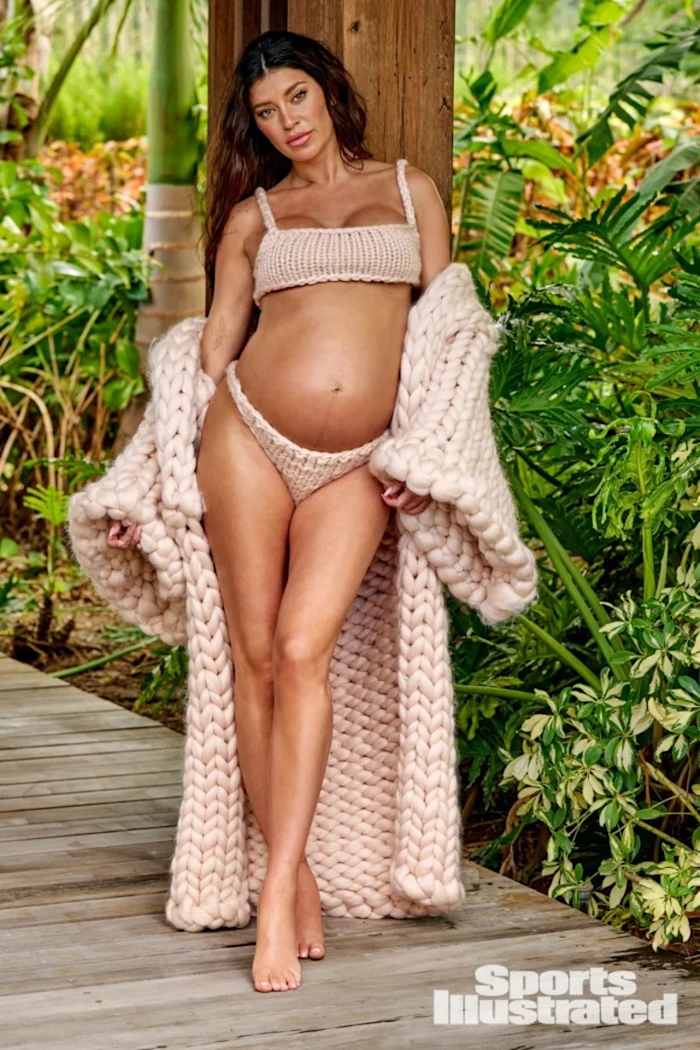 Nicole Williams English poses in a knit bikini and oversized floor-length knit sweater.